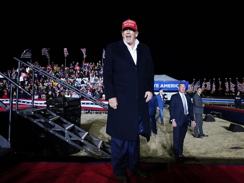 Former President Donald Trump smiles at the crowd after speaking at a rally on Jan. 15 in Florence, Ariz.