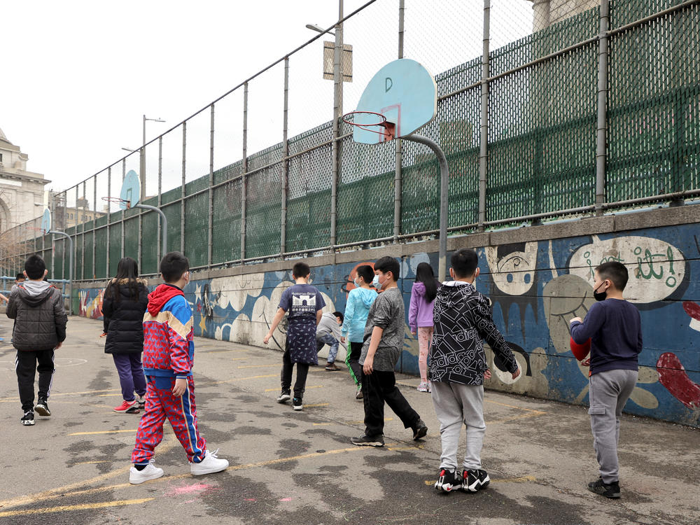 Students play at recess on an outdoor court at Yung Wing School P.S. 124 on March 7, 2022, in New York City.