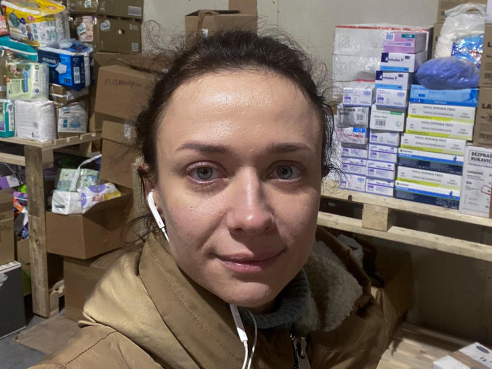 Aleksandra Shchebet takes a selfie in a warehouse in Lutsk where she spends long days packing up donated food and medical supplies. The neurologist from Kyiv, who turns 37 on Sunday, March 20, fled the bombing but stayed in Ukraine to help by offering consultations online and on the phone as well as volunteering in the warehouse.