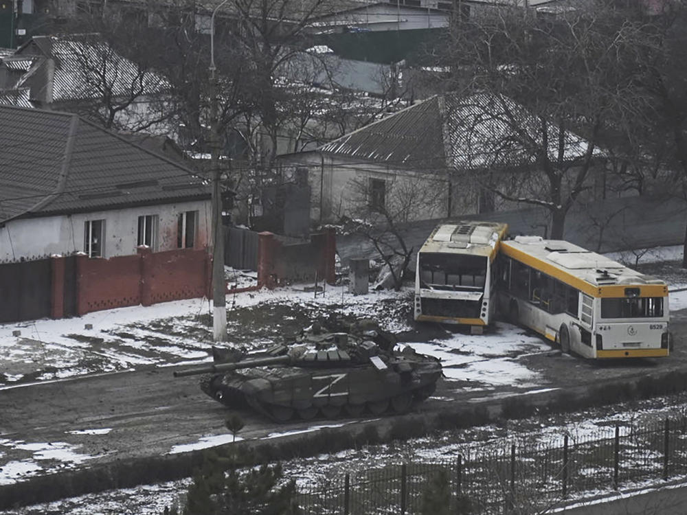A Russian army tank moves through a street on the outskirts of Mariupol, Ukraine, on Friday, March 11, 2022.