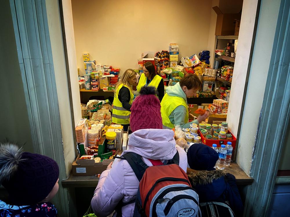 Crowds of refugees line up to get basic food.