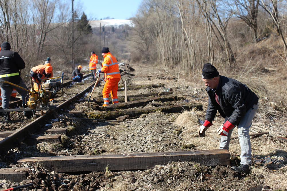 The workers are replacing the railroad ties.
