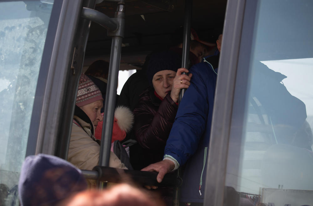 Ukrainian refugees board a bus bound for a nearby reception center.