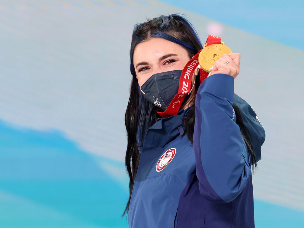 Gold medalist Brenna Huckaby of Team USA celebrates on the podium during the medal ceremony for the women's banked slalom SB-LL2.
