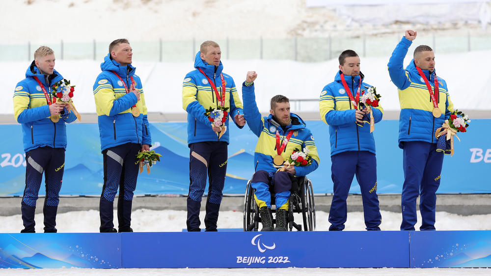 Dmytro Suiarko, Grygorii Vovchynskyi, Vasyl Kravchuk and Anatolii Kovalevskyi of Team Ukraine pose with their gold medals following the para cross-country open 4x2.5km relay during day nine of the Beijing 2022 Winter Paralympics.