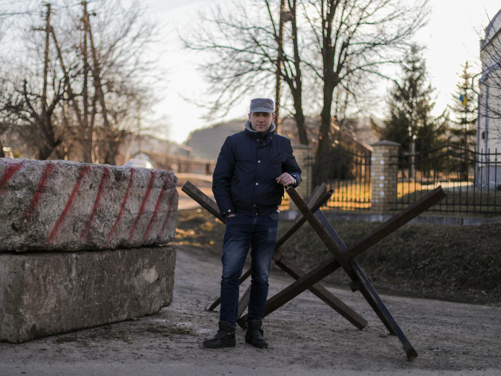 Oleh Pokrovsky helps man a small checkpoint on a bumpy road leading to his village. 