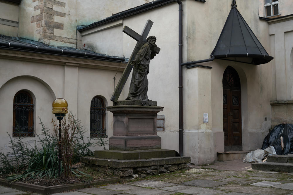 A statue of Jesus Christ, later wrapped in protective materials, stands outside Lviv's Armenian Cathedral, which dates back to the 1300s.