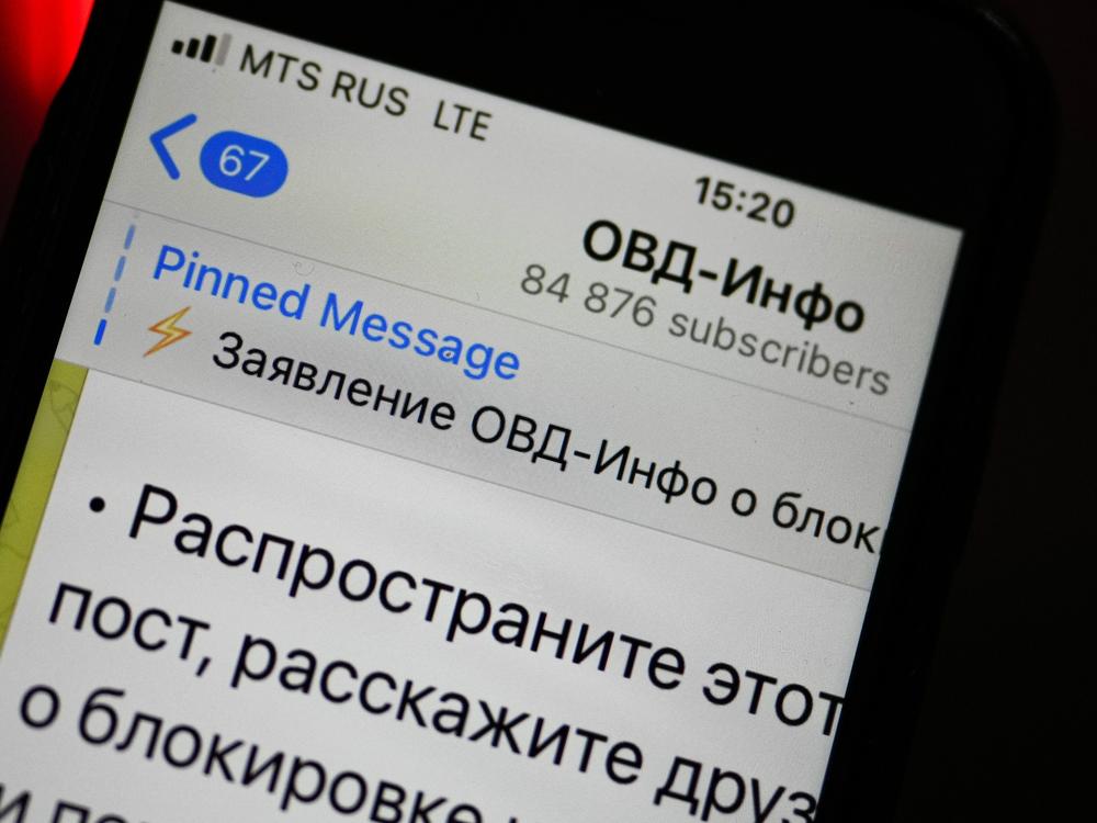 An iPhone screen shows a Telegram account of OVD-Info, prominent legal aid group in Russia that tracks political arrests in Moscow.