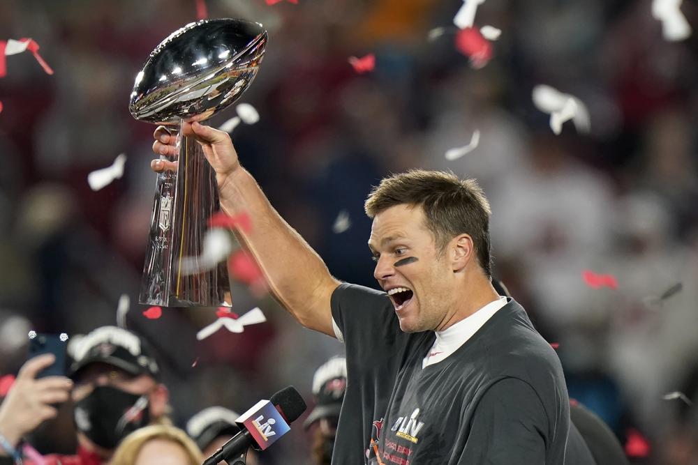 Tampa Bay Buccaneers quarterback Tom Brady celebrates with the Vince Lombardi Trophy after the team's NFL Super Bowl 55 football game against the Kansas City Chiefs in Tampa, Fla.