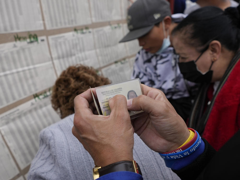 People check a voter list to confirm where they should cast their ballots during legislative elections in Bogota, Colombia, on Sunday.