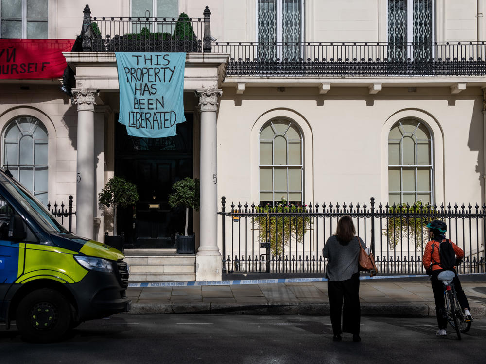 Protesters occupy a building reportedly belonging to Russian oligarch Oleg Deripaska on Monday in London.