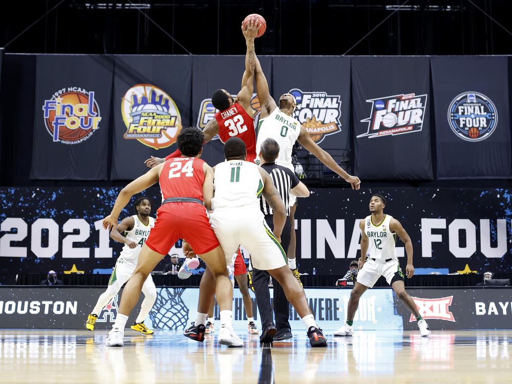For the first time in the history of the March Madness tournament, NCAA athletes will be able to profit off their names, images and likenesses. Above, Reggie Chaney of the Houston Cougars and Flo Thamba of the Baylor Bears compete for the opening tipoff during the 2021 tournament.