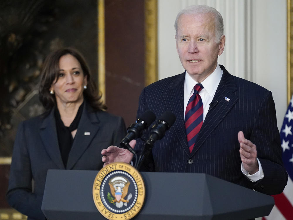 Vice President Kamala Harris listens as President Joe Biden speaks before signing the Consolidated Appropriations Act for Fiscal Year 2022 in the Eisenhower Executive Office Building on Tuesday, March 15, 2022. Harris' office later announced that her husband, second gentleman Douglas Emhoff, had tested positive for COVID-19.