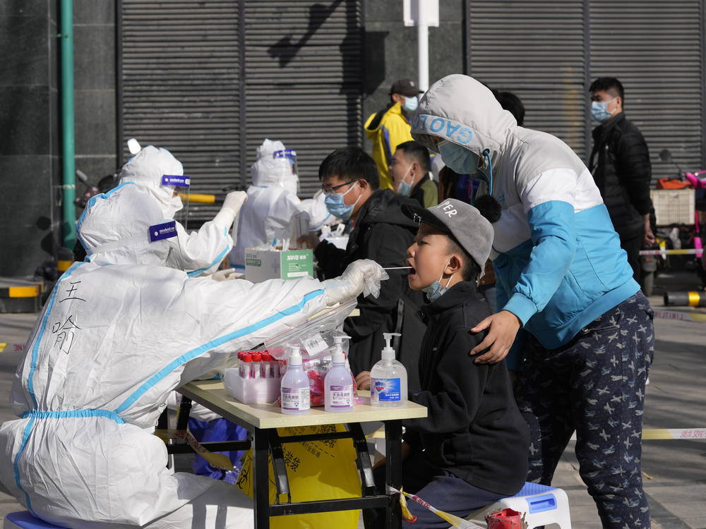 Residents get tested for the coronavirus at an outdoor facility on Monday in Beijing.