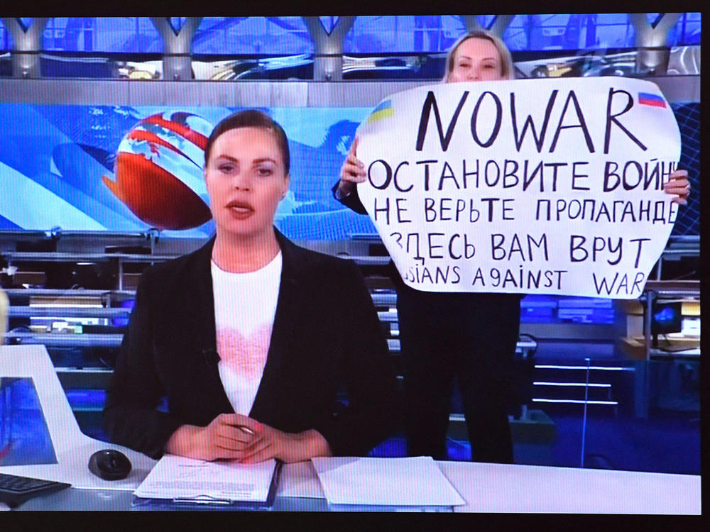 Russian Channel One employee Marina Ovsyannikova interrupted a live broadcast in Moscow on Monday, holding up a poster reading 