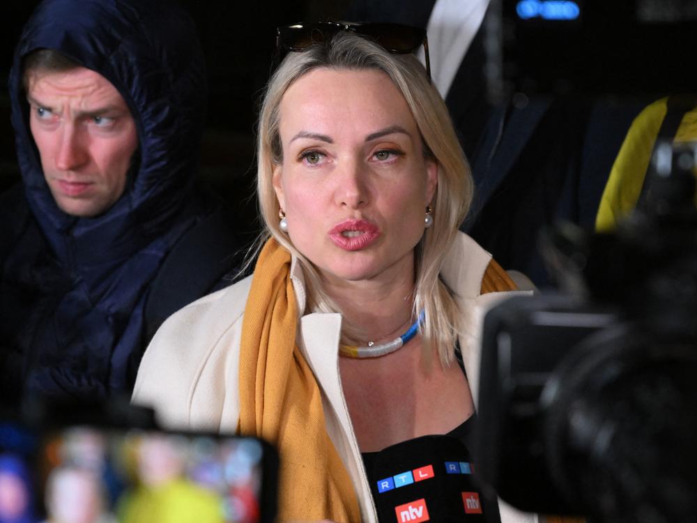 Marina Ovsyannikova, an editor at the state broadcaster Channel One who protested against Russian military action in Ukraine during the evening news show at the station late Monday, speaks to the media Tuesday as she leaves the Ostankinsky District Court after being fined 30,000 rubles ($280) for breaching protest laws in Moscow.