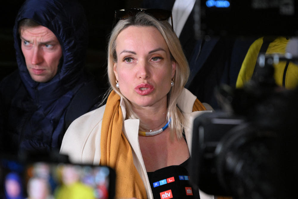 Marina Ovsyannikova, the editor at state broadcaster Channel One who protested Russian military action in Ukraine by interrupting a Monday news broadcast, speaks to the media in Moscow as she leaves the Ostankinsky District Court on Tuesday after being fined for breaching protest laws.