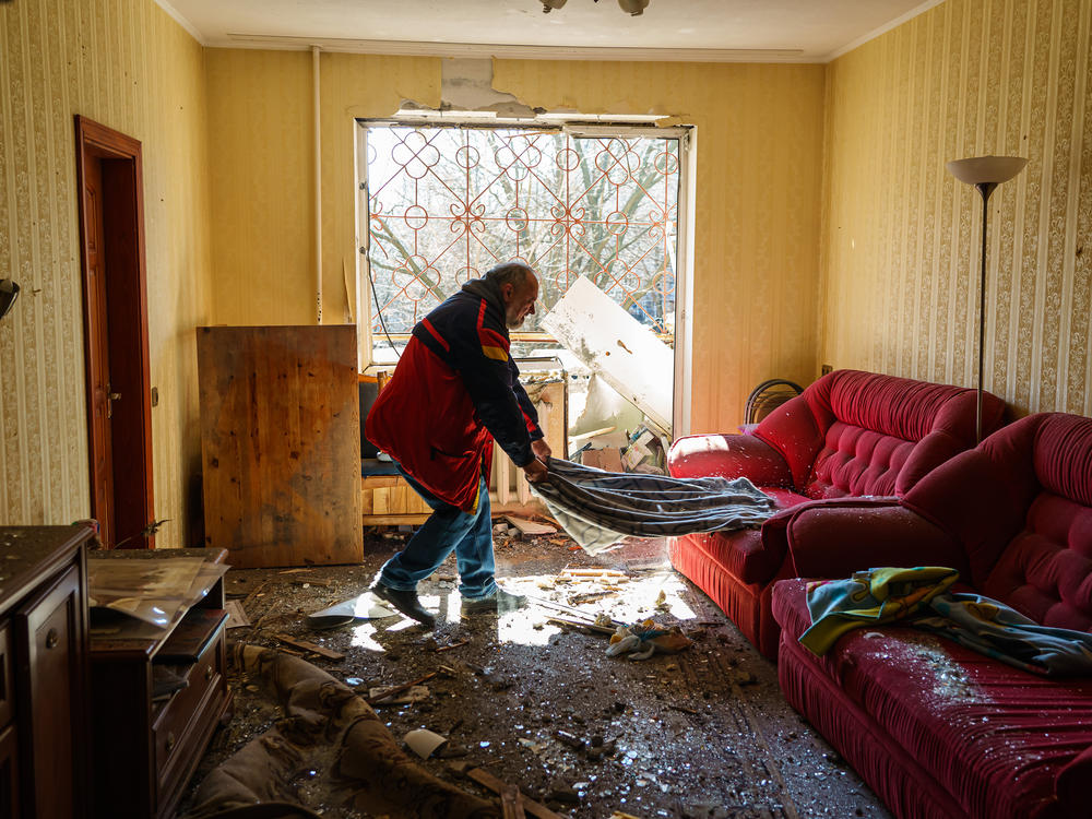 Local residents recover, pack and clean out their homes in a damaged residential building in the Vynogradir district of Kyiv on Tuesday. Authorities said the damage was caused by a Russian bombardment.