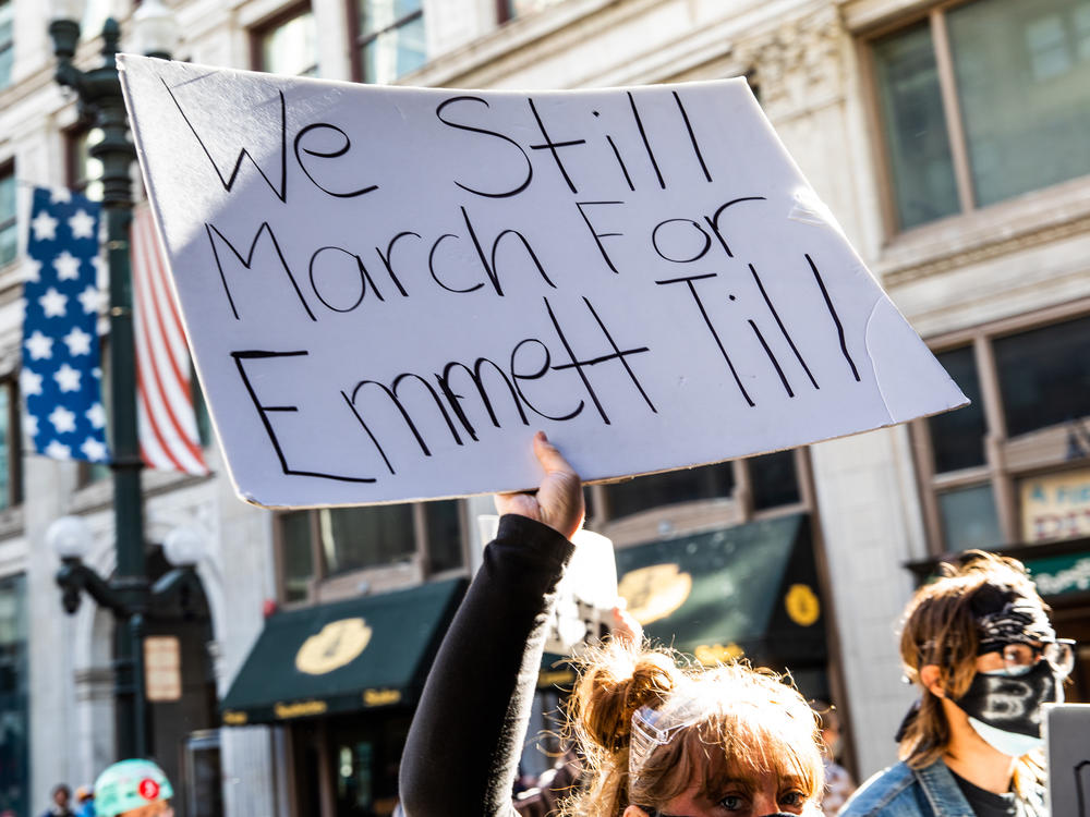 A woman holds a sign in honor of Emmett Till during a protest on June 13, 2020, in Chicago. Protests erupted across the U.S. after George Floyd was killed while in police custody in Minneapolis on May 25, 2020.