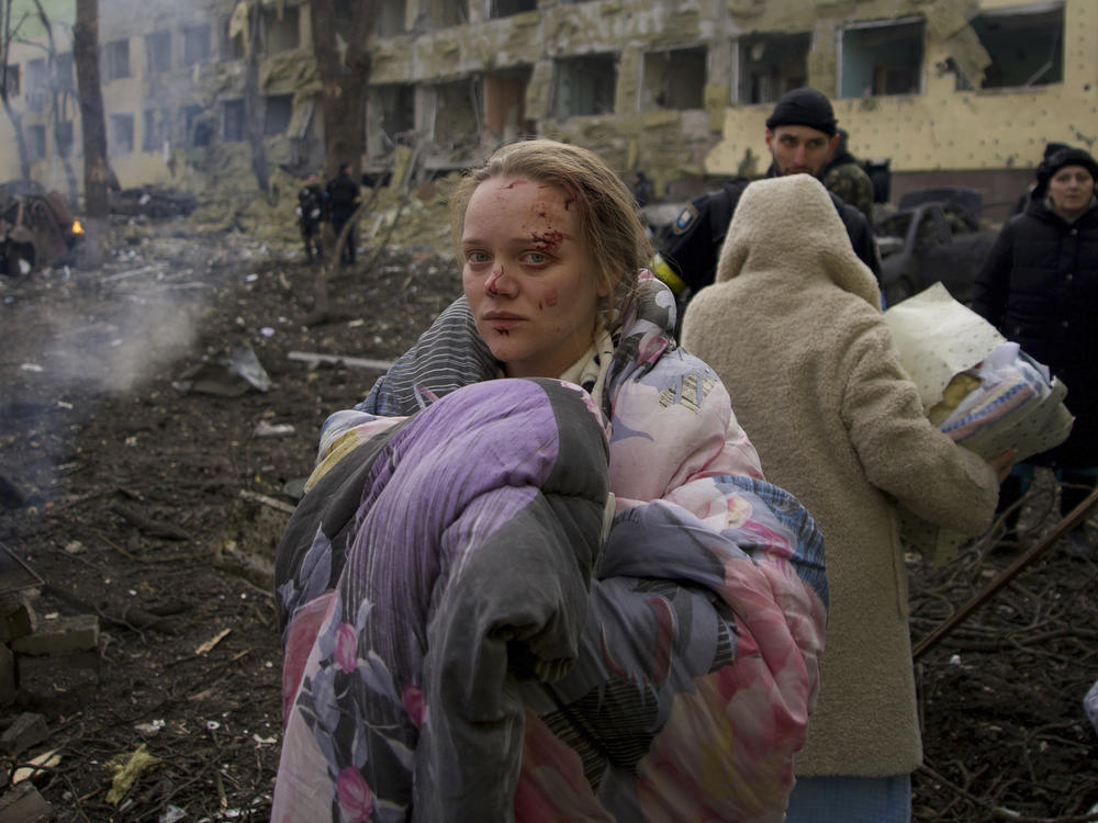 Mariana Vishegirskaya stands outside a maternity hospital that was damaged by shelling in Mariupol, Ukraine, on March 9. Vishegirskaya later gave birth to a girl in another hospital in Mariupol.