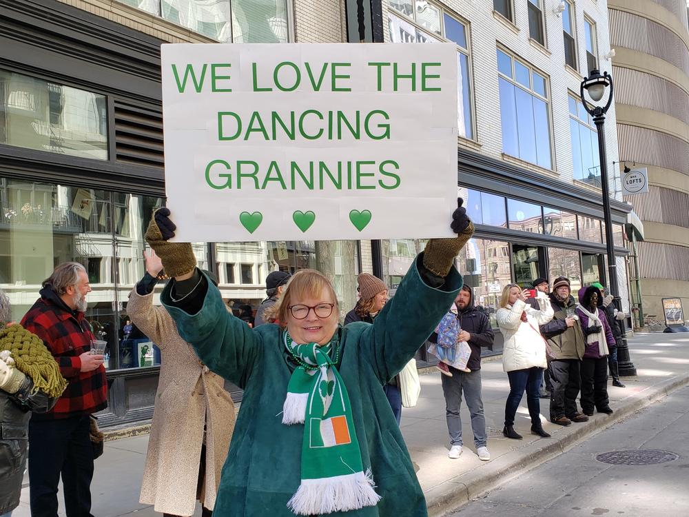 A supporter of the Dancing Grannies holds a sign honoring the dance group during the 2022 Milwaukee St. Patrick's Day parade. The Milwaukee-based group made its first appearance since the deadly Waukesha Christmas parade attack last November that killed three of its dancers.
