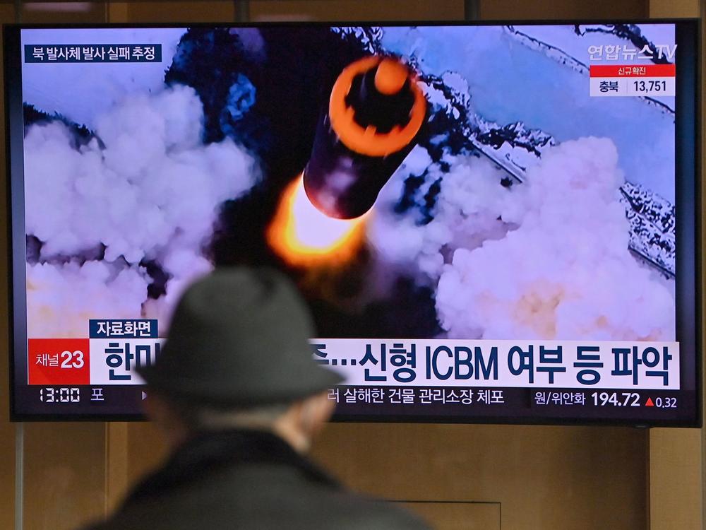 People watch a television screen showing a news broadcast with file footage of a North Korean missile test, at a railway station in Seoul on Wednesday, after North Korea fired an 