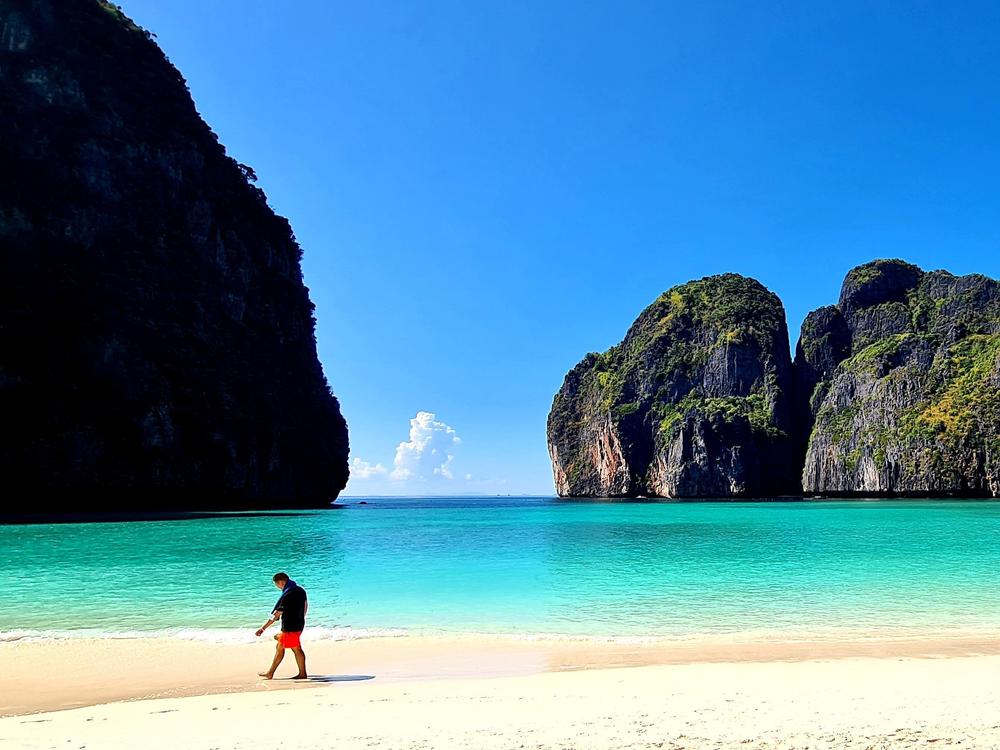 A tourist strolls along the white sand of Maya Beach in Thailand. The destination was once overrun by visitors, but thanks in part to the pandemic, its ecosystem has had time to recover.