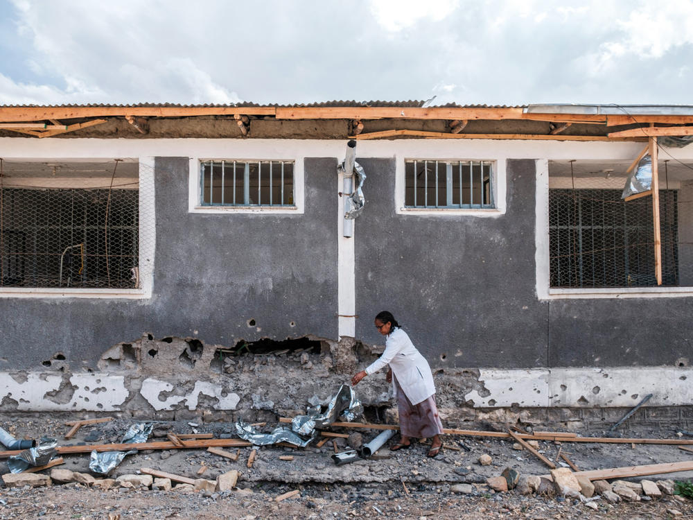 A nurse moves scrap from a damaged part of the Wukro General Hospital, which was shelled as government-aligned forces entered the city in the Tigray region of Ethiopia on February 28, 2021.