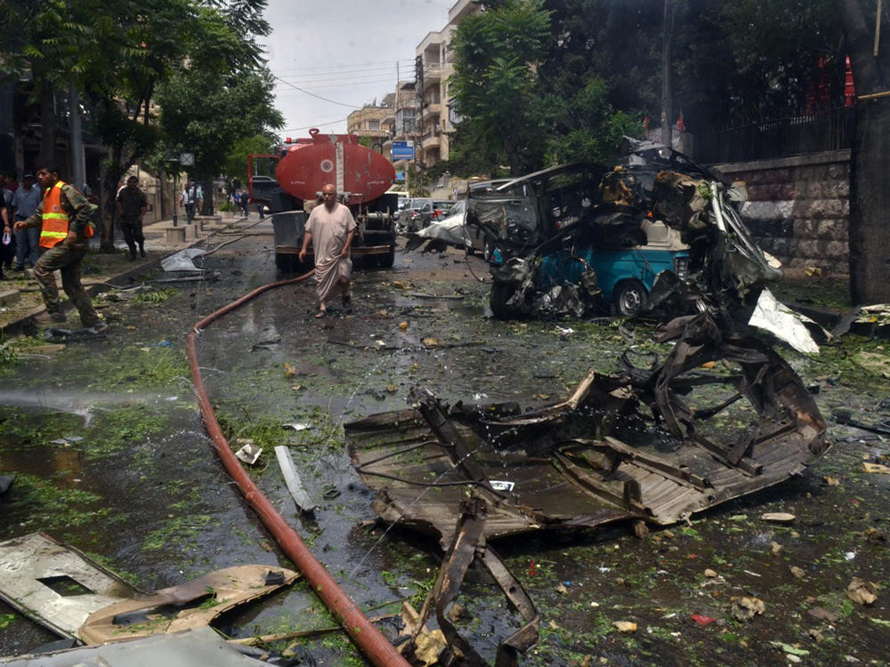 In this photo from May 2016, citizens and firefighters gather at the scene after a rocket hit the Dubeet hospital in Aleppo, Syria. As attacks have continued during the war, some health-care facilities have moved underground to try and serve their patients in relative safety.