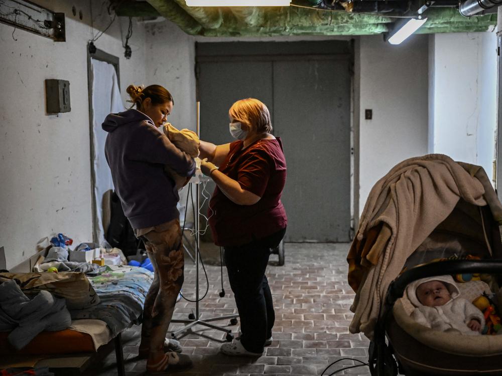 A nurse checks a baby in a hospital basement being used as a bomb shelter in Kyiv, Ukraine. More than 300 health facilities lie within conflict lines or areas that Russia claims to control, according to the World Health Organization.