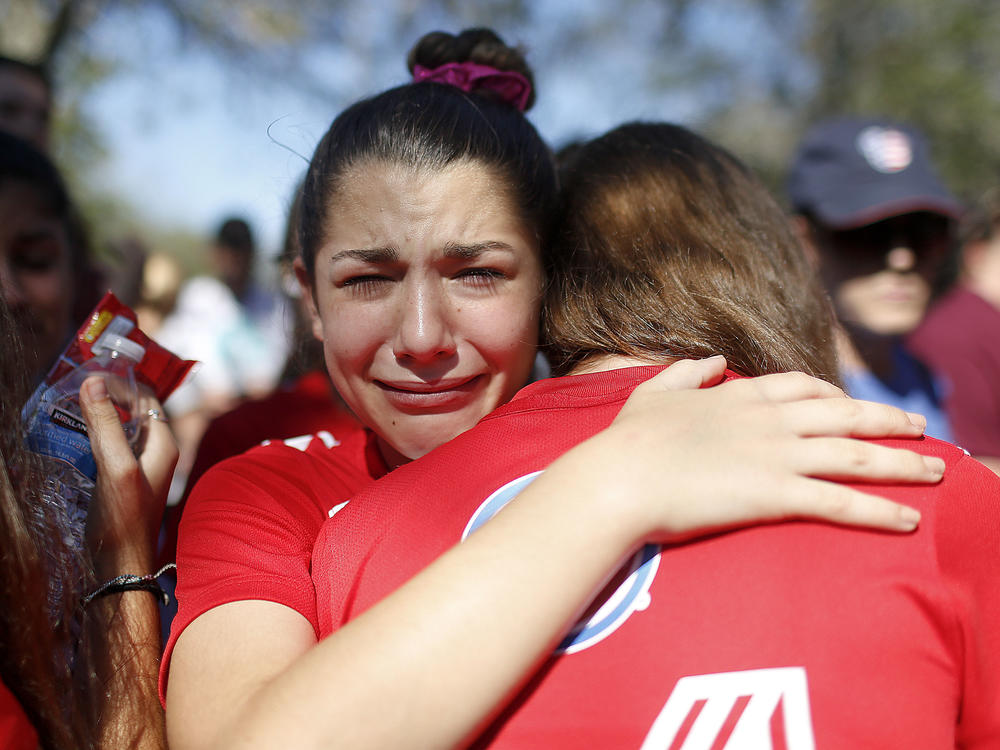A student mourns the loss of her friend during a community vigil at Pine Trails Park on Feb. 15, 2018, in Parkland, Fla.