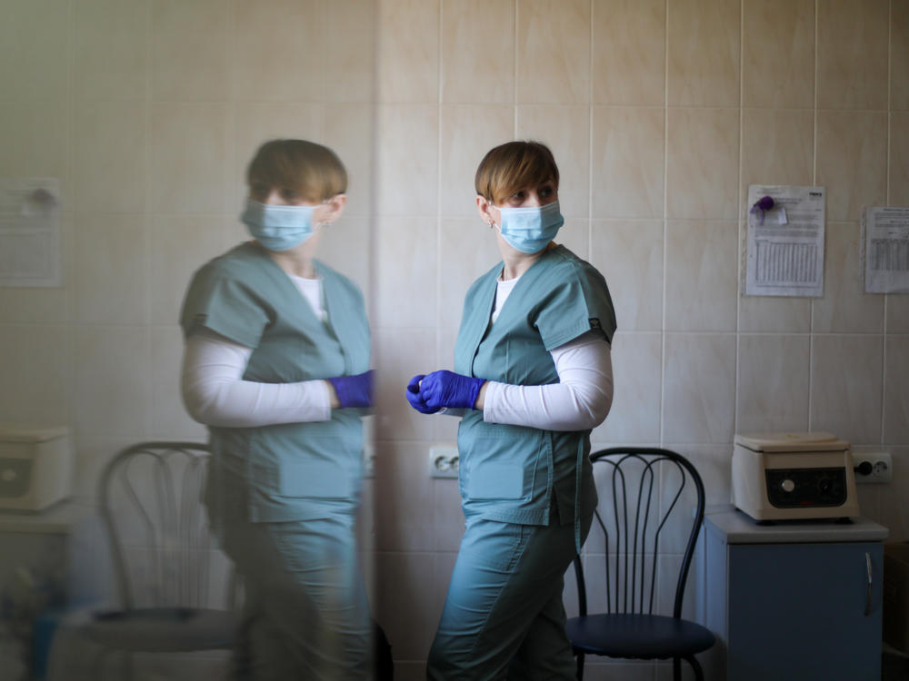 A nurse administers a shot to a patient.