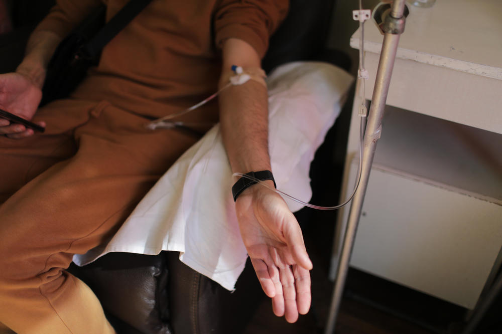 A patient sits in a chair while being treated. Doctors say they're treating patients who are dealing with the double trauma of fighting to heal while trying to survive Russia's invading forces.