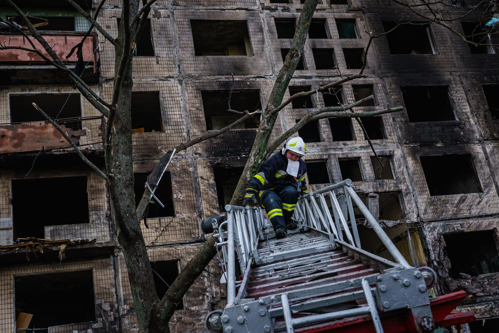 Firefighters investigate what Kyiv officials claim is a Russian bombardment on an apartment building in the Obolon neighborhood of Irpin, Ukraine, Monday, March 14, 2022.