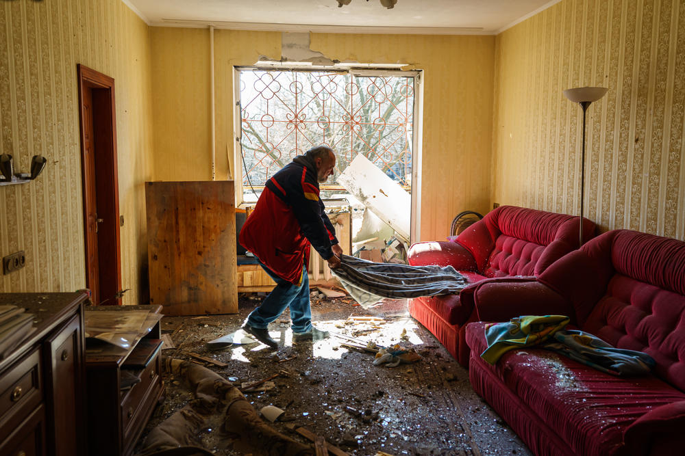 Local residents, recover, pack and clean out their damaged homes in a residential building caused by what authorities said is a Russian bombardment, in the Vynogradir district of Kyiv, Ukraine, Tuesday, March 15, 2022.