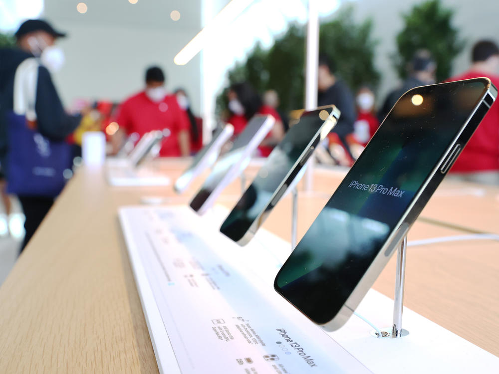 iPhones are displayed as people attend the grand opening event of a new Apple store in Los Angeles on Nov. 19, 2021.