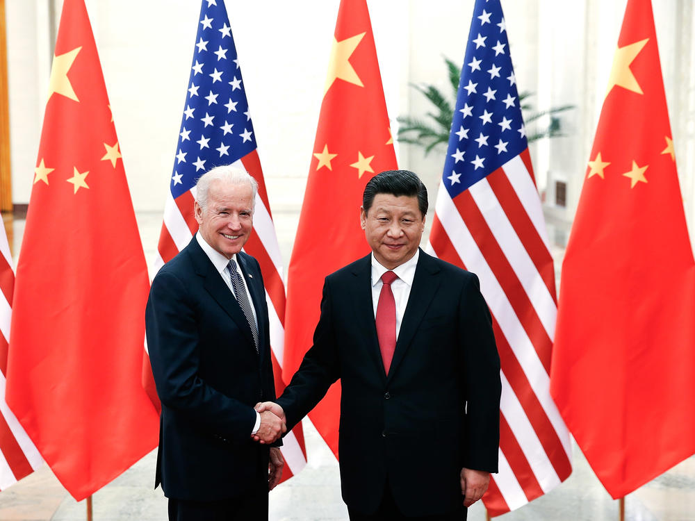 Chinese President Xi Jinping shakes hands with then-U.S Vice President Joe Biden inside the Great Hall of the People on December 4, 2013, in Beijing.