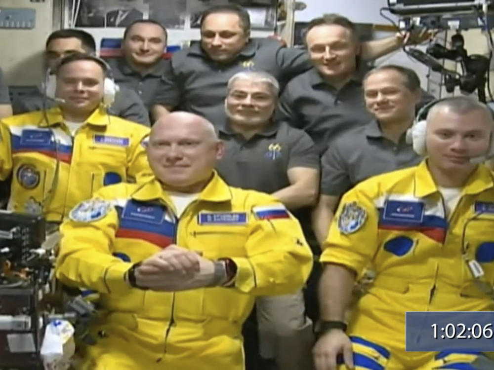Russian cosmonauts (from left) Sergey Korsakov, Oleg Artemyev and Denis Matveev wear yellow at the International Space Station.