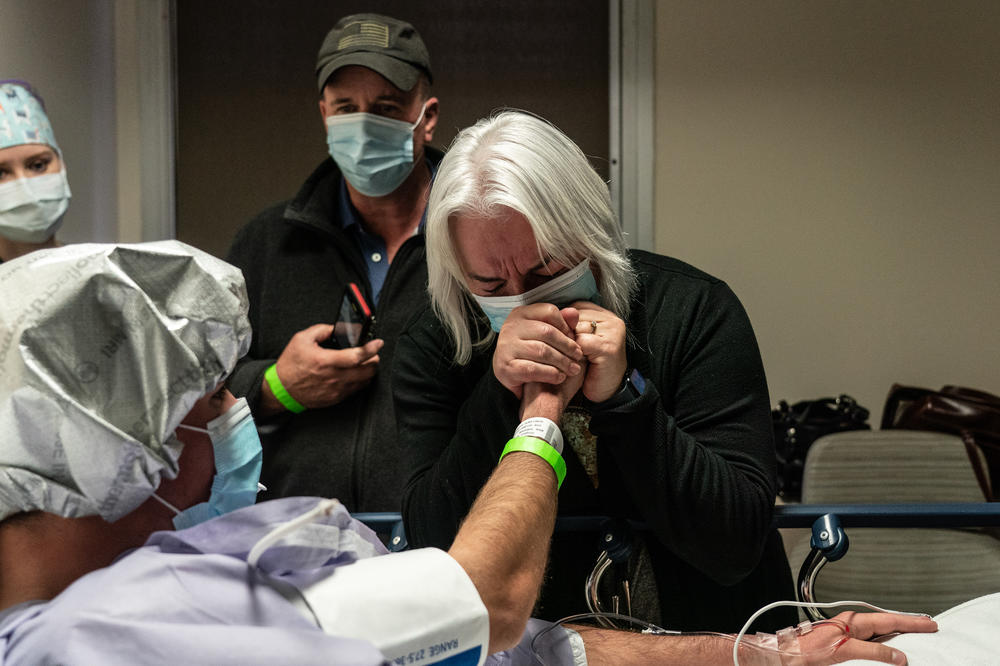 Adrien Wingard grabs her son Michael Wingard's hand in Houston Methodist Hospital before Michael's surgery to donate his kidney.