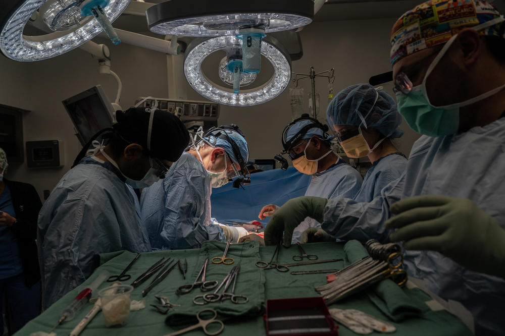 Dr. A. Osama Gaber, second from left, and other medical professionals perform a kidney transplant surgery on a recipient patient.