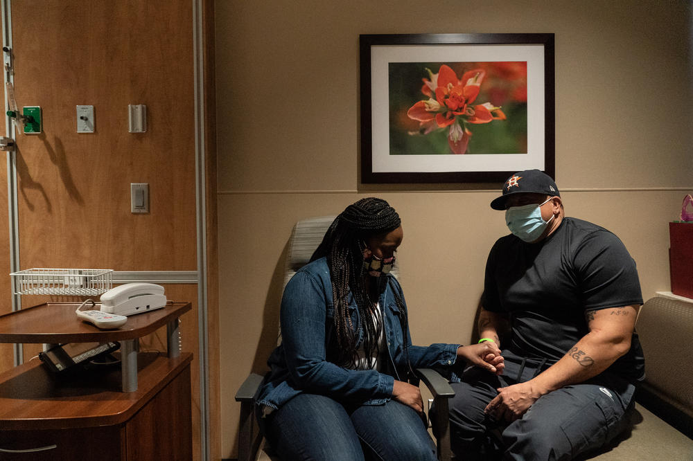 Kidney donor Lisa Jolivet and her husband, Jerrod Jolivet, hold hands together in a patient room in Houston Methodist Hospital on March 1 in Houston.