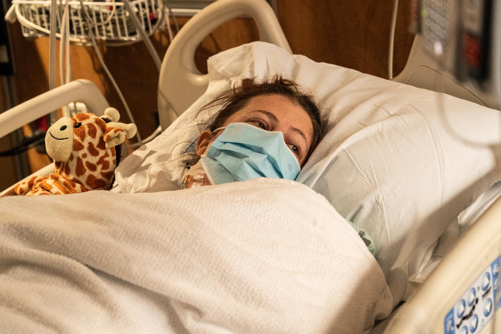 Kidney recipient patient Heather O'Neil Smarrella rests the day after her kidney transplant surgery.