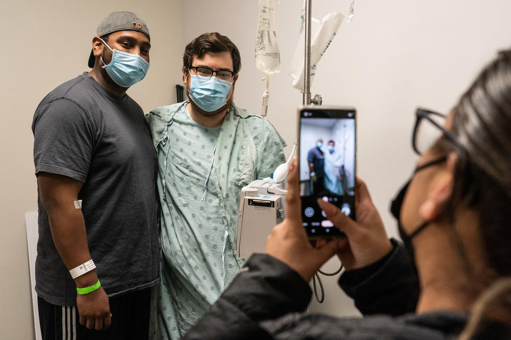 Kidney donor Tomas Martinez and and kidney recipient Chris McLellan pose for a photo during the reveal.