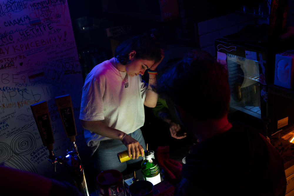 Nastasya Dubovitskaya, 23, was detained in Russia last year after attending a rally. Now, in Tbilisi, she works as a bartender and is saving to donate money to the Ukrainian army.