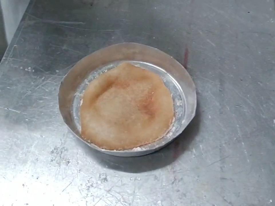 This tiny pizza, a couple inches across, was made in a lab in Naples using a new approach for raising dough that doesn't involve yeast.