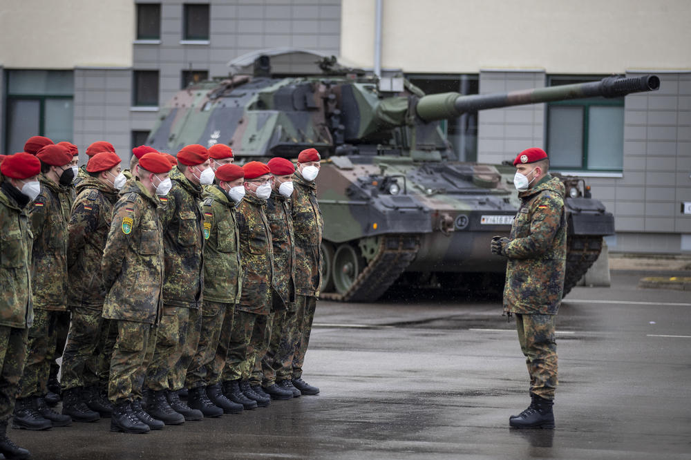 German Bundeswehr soldiers of the NATO enhanced forward presence battalion wait to greet German Defense Minister Christine Lambrecht upon her arrival at Lithuania's Rukla military base on Feb. 22. Germany's chancellor pledged to ramp up defense spending after Russia launched an invasion of Ukraine.