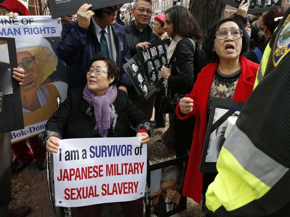 FILE - Lee Yong-soo, a South Korean sexual slavery survivor who has been demanding since the early 1990s that the Japanese government fully accept culpability and offer an unequivocal apology, participates in a protest outside the John F. Kennedy School of Government in Cambridge, Mass., where Japanese then-Prime Minister Shinzo Abe spoke on April 27, 2015.