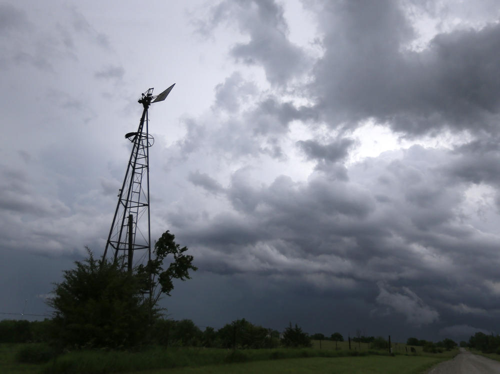 Storm clouds that were part of a system that produced several tornadoes move past a windmill on a farm near Ozawkie, Kan., in 2016.