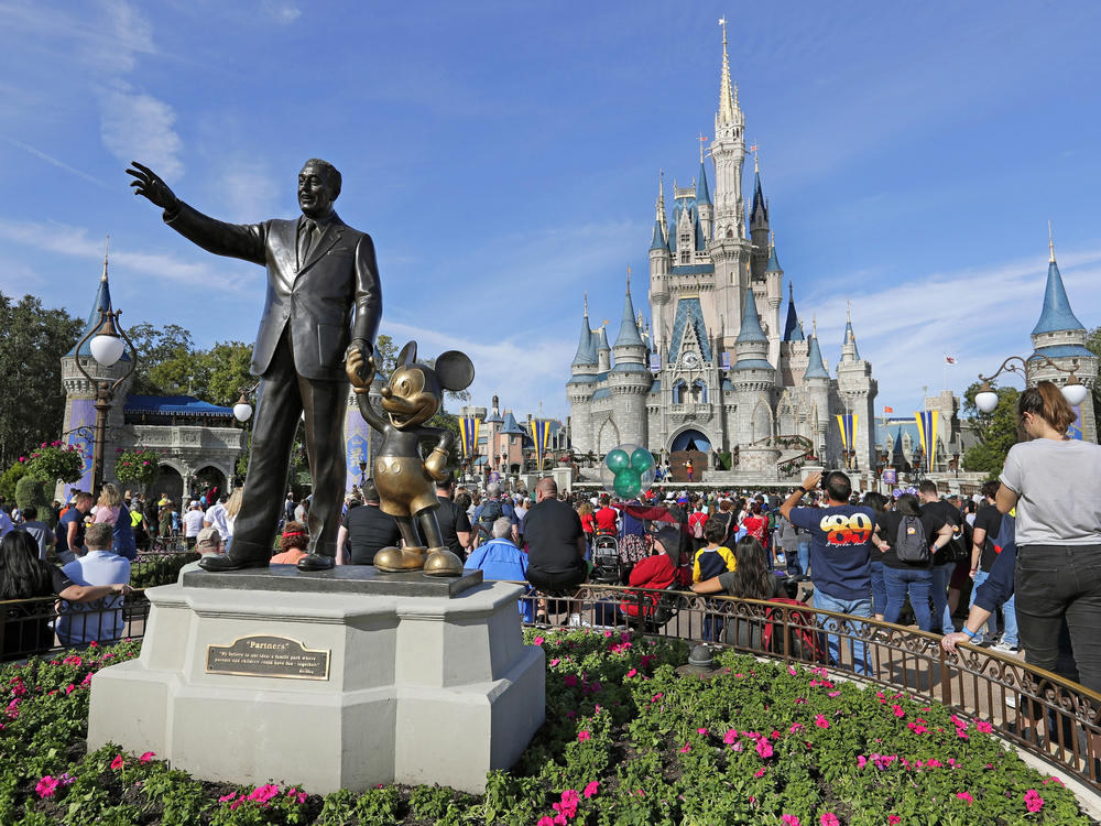 A statue of Walt Disney and Micky Mouse stand near the Cinderella Castle at the Magic Kingdom at Walt Disney World in Lake Buena Vista, Fla. on Jan. 9, 2019.