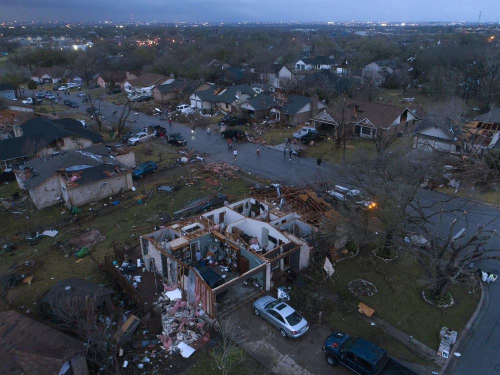 Debris litters the ground surrounding homes, damaged by a tornado in Round Rock, Texas, on Monday.